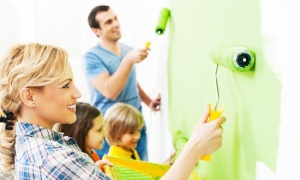 Happy family painting walls.